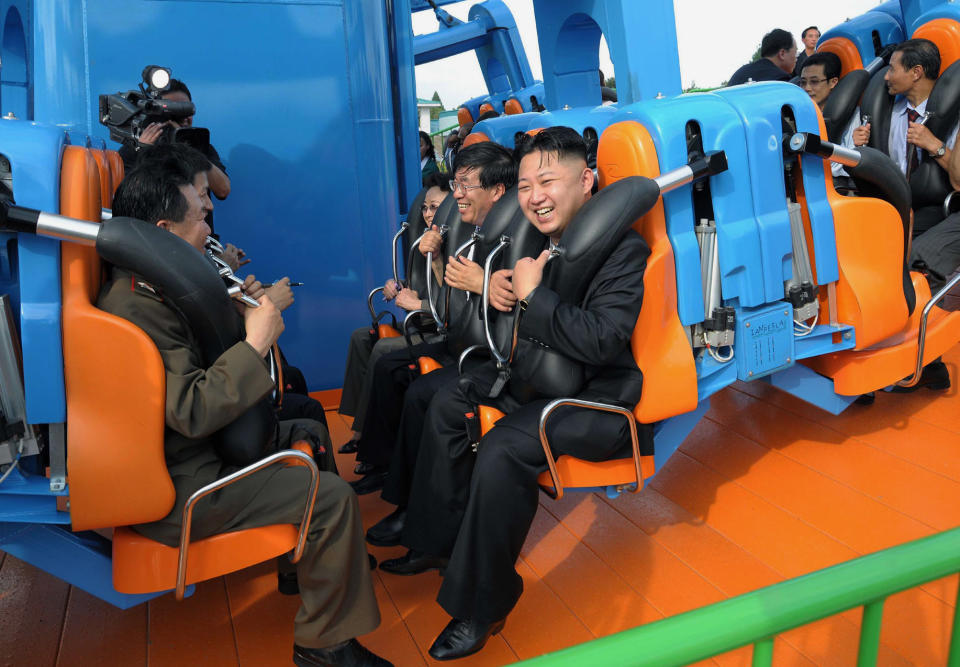 FILE - In this undated file photo released by the North Korean government on July 26, 2012, North Korean leader Kim Jong Un, center, reacts on a ride as he attends the completion ceremony of the Rungna People's Pleasure Ground in Pyongyang, North Korea. Since taking power after his father's death in 2011, Kim has spent 10 years erasing doubts that he was too young and weak to extend his family’s brutal dynastic grip over the impoverished, nuclear-armed state. Independent journalists were not given access to cover the event depicted in this image distributed by the North Korean government. The content of this image is as provided and cannot be independently verified. (Korean Central News Agency/Korea News Service via AP, File)