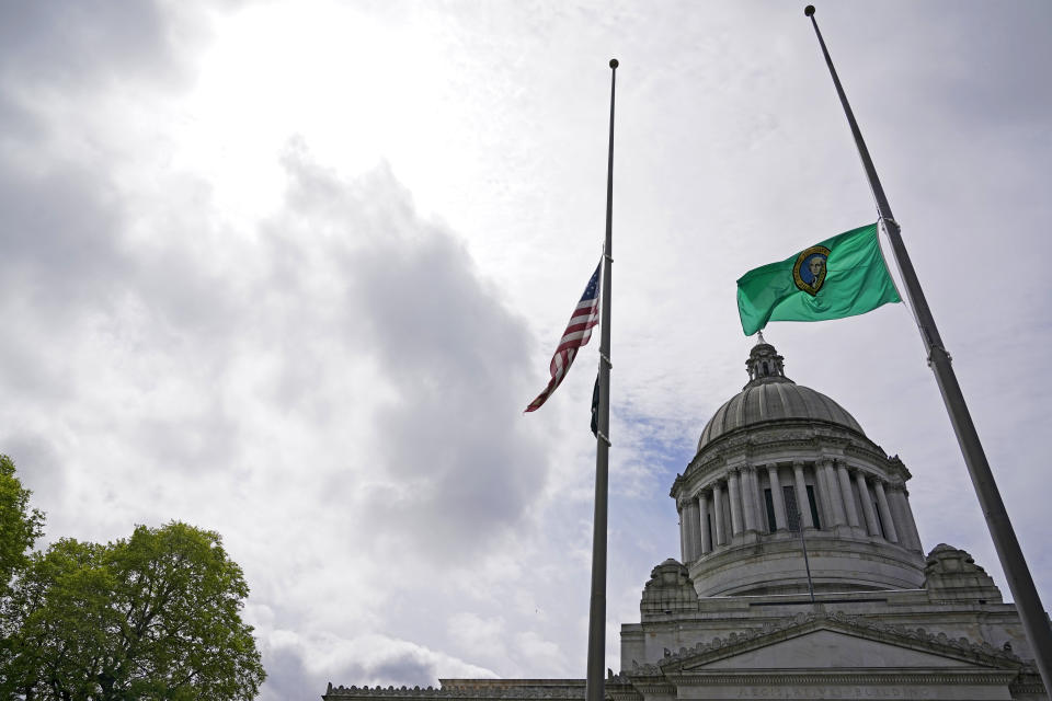 The U.S. and Washington state flags fly at half-staff in front of the Legislative Building at the Capitol in Olympia, Wash., Wednesday, May 25, 2022, in memory of the victims of the mass shooting in Uvalde, Texas. Washington Gov. Jay Inslee was quick to react to the carnage at a Texas elementary school, sending a Twitter message listing the gun control measures the Democratic-controlled state has taken. He finished with: “Your turn Congress.” (AP Photo/Ted S. Warren)