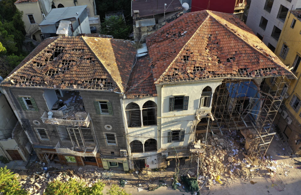 Heritage houses that were destroyed in Aug. 4 explosion that hit the seaport of Beirut, are seen hold by scaffolding, in Beirut, Lebanon, Tuesday Aug. 25, 2020. In the streets of Beirut historic neighborhoods, workers are erecting scaffolding to support buildings that have stood for more than a century - now at risk of collapse after the massive Aug. 4 explosion that tore through the capital. (AP Photo/Hussein Malla)