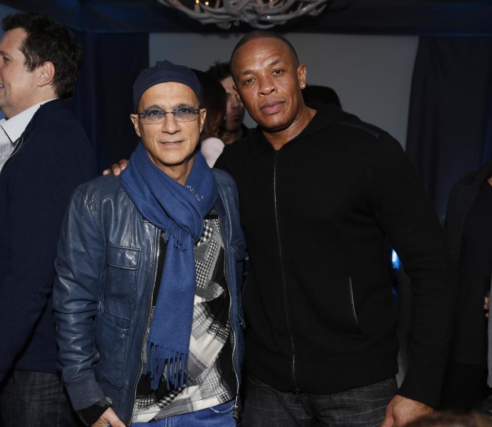 FILE - This Feb. 10, 2013 file photo shows music industry entrepreneur Jimmy Iovine, left, and hip-hop mogul Dr. Dre at a Grammy Party in Los Angeles. It’s as if anything Iovine and Dre touches turns to gold: The dynamic duo marked epic-level success when they introduced Eminem to the music world 15 years ago, and their lucrative Beats by Dre business reached blockbuster heights following reports on Thursday, May 8, 2014, that Apple plans to by the headphone’s parent company, Beats Electronics, for $3.2 billion. (Photo by Todd Williamson/Invision/AP, file)