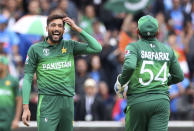 Pakistan's Mohammad Amir, left, reacts after dismissing India's Hardik Pandya during the Cricket World Cup match between India and Pakistan at Old Trafford in Manchester, England, Sunday, June 16, 2019. (AP Photo/Aijaz Rahi)