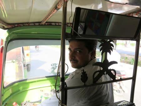 Rixi rickshaw driver Saeed Akhtar sits in his rickshaw in Lahore, Pakistan May 19, 2016. REUTERS/Asad Hashim