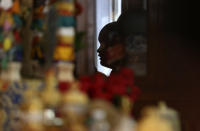 Jalue Dorje is reflected in the mirror of a shrine while reciting prayers during a ceremony on Monday, July 19, 2021, in Columbia Heights, Minn., paying homage to Guru Rinpoche, the Indian Buddhist master who brought Tantric Buddhism to Tibet. When he was an infant, Jalue, now 14, was identified as the eighth reincarnation of the lama Terchen Taksham Rinpoche. After finishing high school in 2025, Jalue will head to northern India and join the Mindrolling Monastery, more than 7,200 miles (11,500 kilometers) from his home. (AP Photo/Jessie Wardarski)