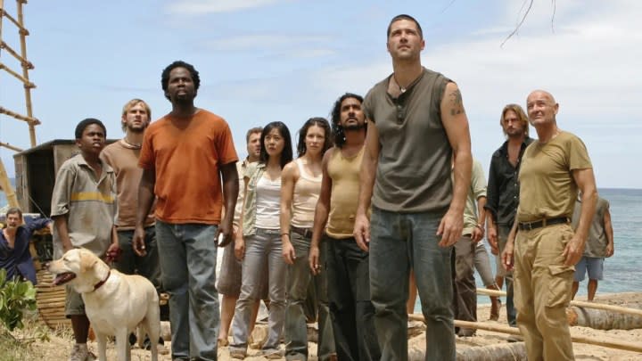 A group of people look up in Lost.