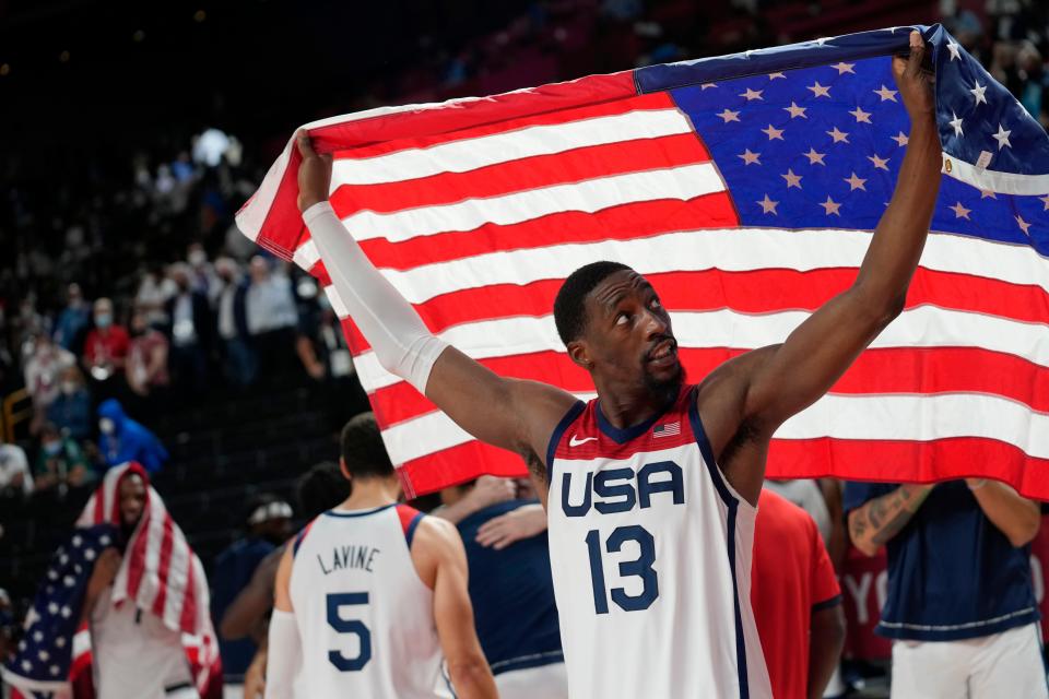 United States' Bam Adebayo (13) waves the United States flag as he celebrates with teammates after their win over France in a men's basketball Gold medal game at the 2020 Summer Olympics, Saturday, Aug. 7, 2021, in Saitama, Japan. (AP Photo/Eric Gay)