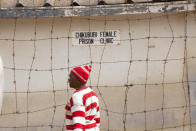 A female prisoner is seen inside the prison premises at Chikurubi prison on the outskirts of Harare, Saturday, April 17, 2021. Zimbabwe began the release of about 3,000 prisoners under a presidential amnesty aimed at easing congestion and minimizing the threat of COVID-19 across the country's overcrowded jails. (AP Photo/Tsvangirayi Mukwazhi)