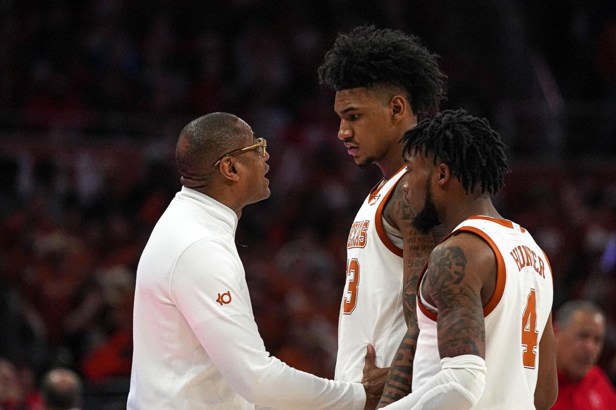 Texas men's basketball coach Rodney Terry talks to forward Dillon Mitchell and guard Tyrese Hunter during Monday night's 76-72 overtime loss to No. 4 Houston. The Longhorns face another Top 25 challenge Saturday at TCU.
