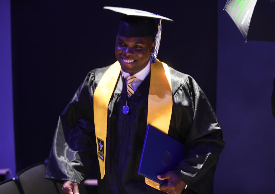 Gabriel McMinn walks off the stage after earning his Associate of Science in Nursing degree from Keiser University during the college's commencement ceremony at Westside Church on Friday, June 2, 2023, in Fort Pierce. McMinn would like to become a Certified Registered Nurse Anesthetist.