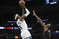 Minnesota Timberwolves forward Jaden McDaniels (3) shoots over Toronto Raptors guard Immanuel Quickley (5) during the second half of an NBA basketball game, Wednesday, April 3, 2024, in Minneapolis. (AP Photo/Abbie Parr)