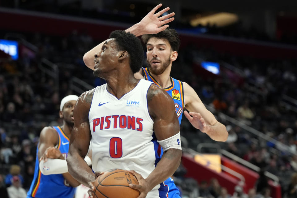 Detroit Pistons center Jalen Duren (0) is defended by Oklahoma City Thunder forward Chet Holmgren (7) during the first half of an NBA basketball game, Sunday, Jan. 28, 2024, in Detroit. (AP Photo/Carlos Osorio)