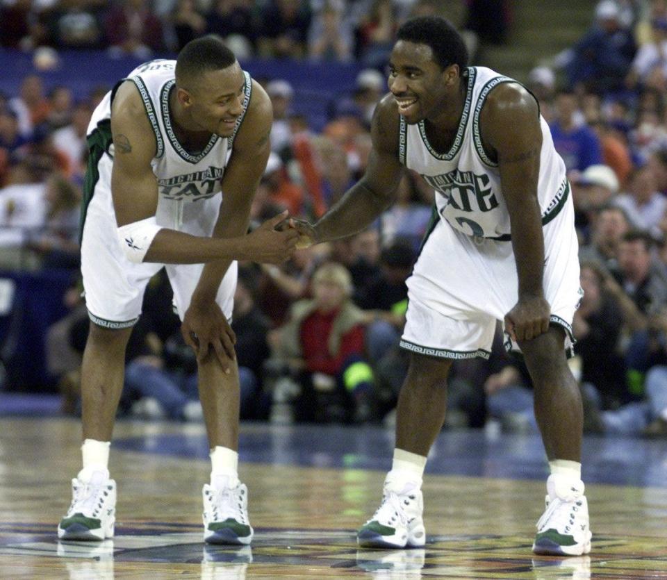Morris Peterson, left, and Mateen Cleaves celebrate at midcourt with 1 minute to go in the 53-41 win over Wisconsin in the Final Four semifinal Saturday, April 1, 2000 in Indianapolis.