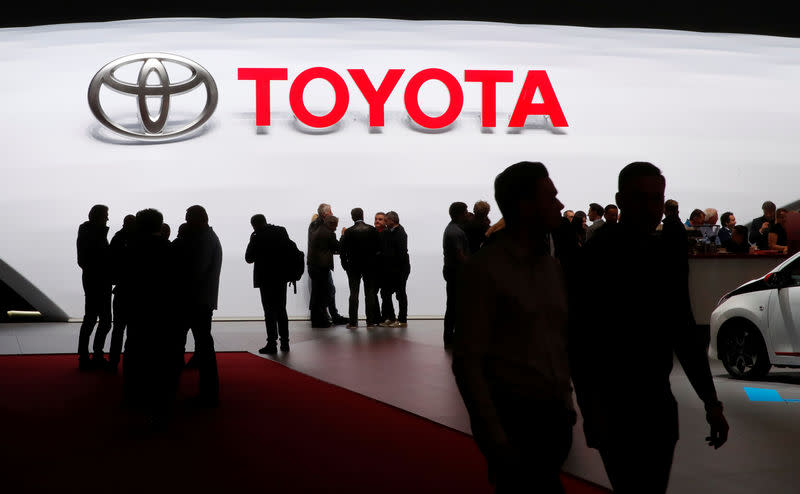 Visitors look at car models on the Toyota stand during the 88th Geneva International Motor Show in Geneva, Switzerland, March 7, 2018. REUTERS/Denis Balibouse