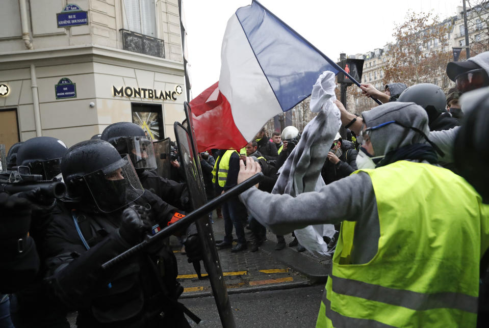 Police officers clash with demonstrators wearing yellow vests in Paris, Saturday, Dec. 8, 2018. (Photo: Thibault Camus/AP)