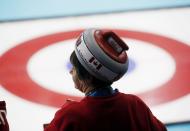 A fan of Canada wearing a hat in the shape of a stone looks on during their men's curling round robin game against Germany at the 2014 Sochi Olympics in the Ice Cube Curling Center in Sochi February 10, 2014. REUTERS/Mark Blinch (RUSSIA - Tags: OLYMPICS SPORT CURLING)