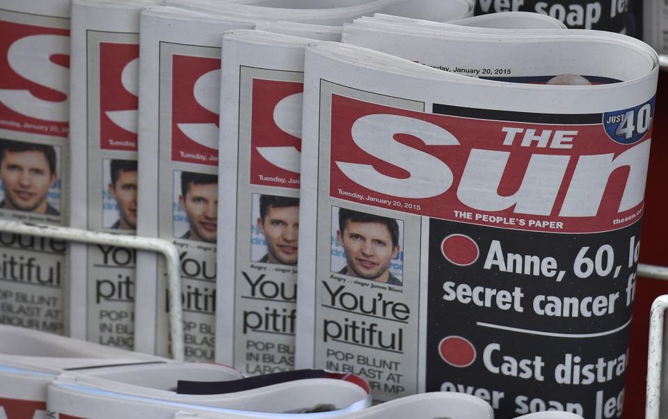 Copies of The Sun newspaper are seen on a newsstand outside a shop in central London January 20, 2015. Britain's The Sun tabloid, the country's best-selling newspaper, has decided to quietly stop publishing photographs of topless models on page three, ending a contested 44-year-old tradition of the Rupert Murdoch-owned paper, The Times reported on Tuesday. REUTERS/Toby Melville (BRITAIN - Tags: MEDIA BUSINESS)