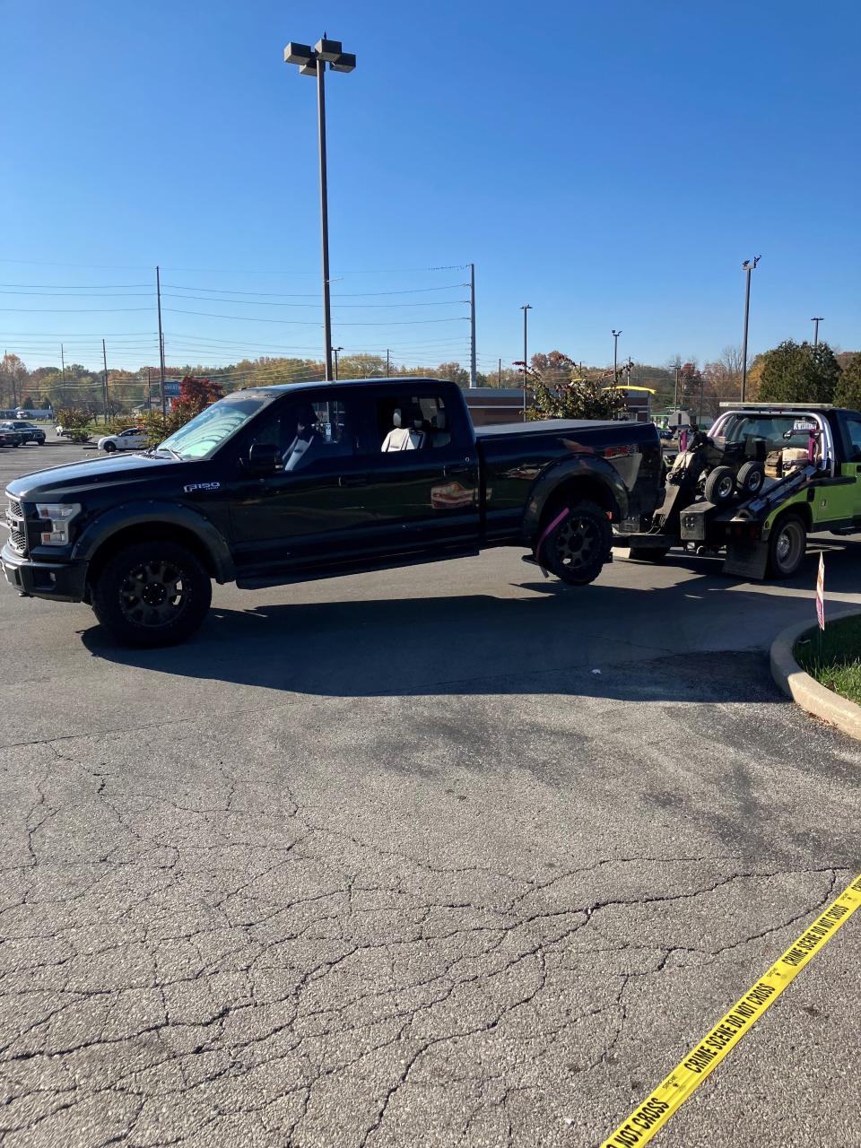 A pick-up truck is towed from a mall at 5900 Madison Ave. on the south side of Indianapolis following a mass shooting that left one person dead and four injured outside GZ Restaurant and Karaoke.
