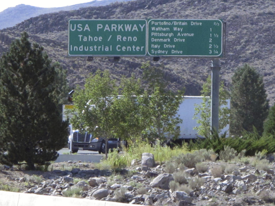 FILE - A truck leaves the Tahoe Reno Industrial Center bound for U.S. Interstate 80 on Thursday, Sept. 4, 2014, 15 miles east of Sparks, Nev. Tesla has confirmed it intends to invest $3.6 billion to expand its manufacturing capabilities in Nevada for "high-volume" production of semi-trucks and make enough cell batteries for 2 million light-duty vehicles annually. (AP Photo/Scott Sonner, File)