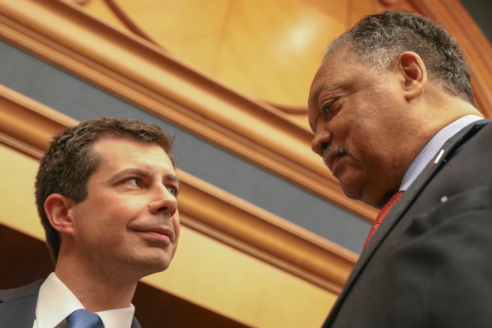 Democratic presidential candidate and South Bend, Ind., Mayor Pete Buttigieg, left, speaks with Rev. Jesse Jackson, right, ahead of a news conference at the Rainbow PUSH Coalition Annual International Convention in Chicago, Tuesday, July 2, 2019.