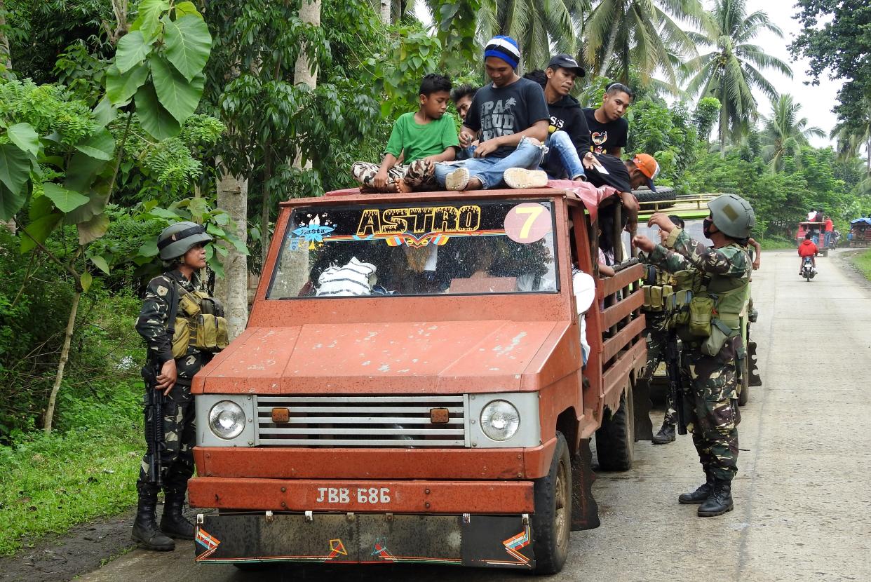 Soldiers inspect a passenger vehicle at a checkpoint in Jolo, Sulu on the southern Philippine Island of Mindanao on July 16, 2017. (Photo: NICKEE BUTLANGAN/AFP via Getty Images)