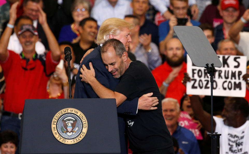 <p>U.S. President Donald Trump hugs a supporter he invited onstage to speak during a “Make America Great Again” rally at Orlando Melbourne International Airport in Melbourne, Florida, February 18, 2017. (REUTERS/Kevin Lamarque) </p>