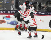 Canada's Danielle Serdachny celebrates her overtime goal over the United States with teammates in their gold medal game at the women's world hockey championships in Utica, N.Y., Sunday, April 14, 2024. (Christinne Muschi/The Canadian Press via AP)