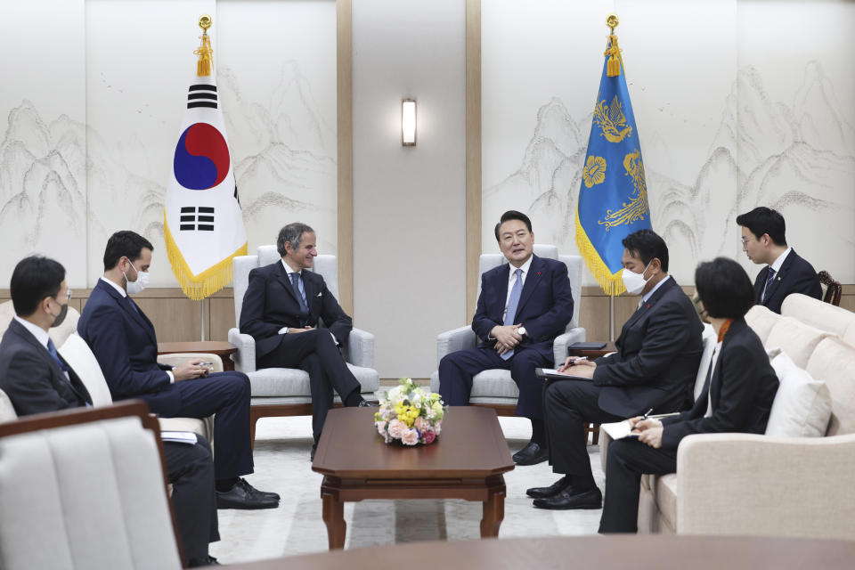 South Korean President Yoon Suk Yeol, center right, talks with Rafael Mariano Grossi, Director General of the International Atomic Energy Agency, center left, during a meeting at the presidential office in Seoul, South Korea, Saturday, July 8, 2023. Hundreds of people marched in South Korea's capital on Saturday demanding Japan scrap its plans to release treated wastewater from the damaged Fukushima nuclear power plant, as the head of the U.N. nuclear agency met with senior officials to discuss public concerns over foods safety. (South Korea Presidential Office/Newsis via AP)