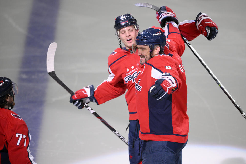 Washington Capitals left wing Alex Ovechkin (8) celebrates his goal with defenseman John Carlson (74) and right wing T.J. Oshie (77) during the third period of an NHL hockey game against the Seattle Kraken, Saturday, March 5, 2022, in Washington. (AP Photo/Nick Wass)