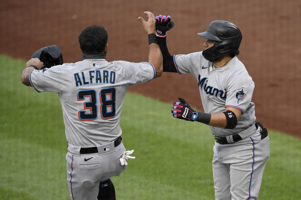 Miami Marlins' Miguel Rojas, right, celebrates his three-run home run with Jorge Alfaro (38) during the second inning of a baseball game against the Washington Nationals, Friday, Aug. 21, 2020, in Washington. (AP Photo/Nick Wass)