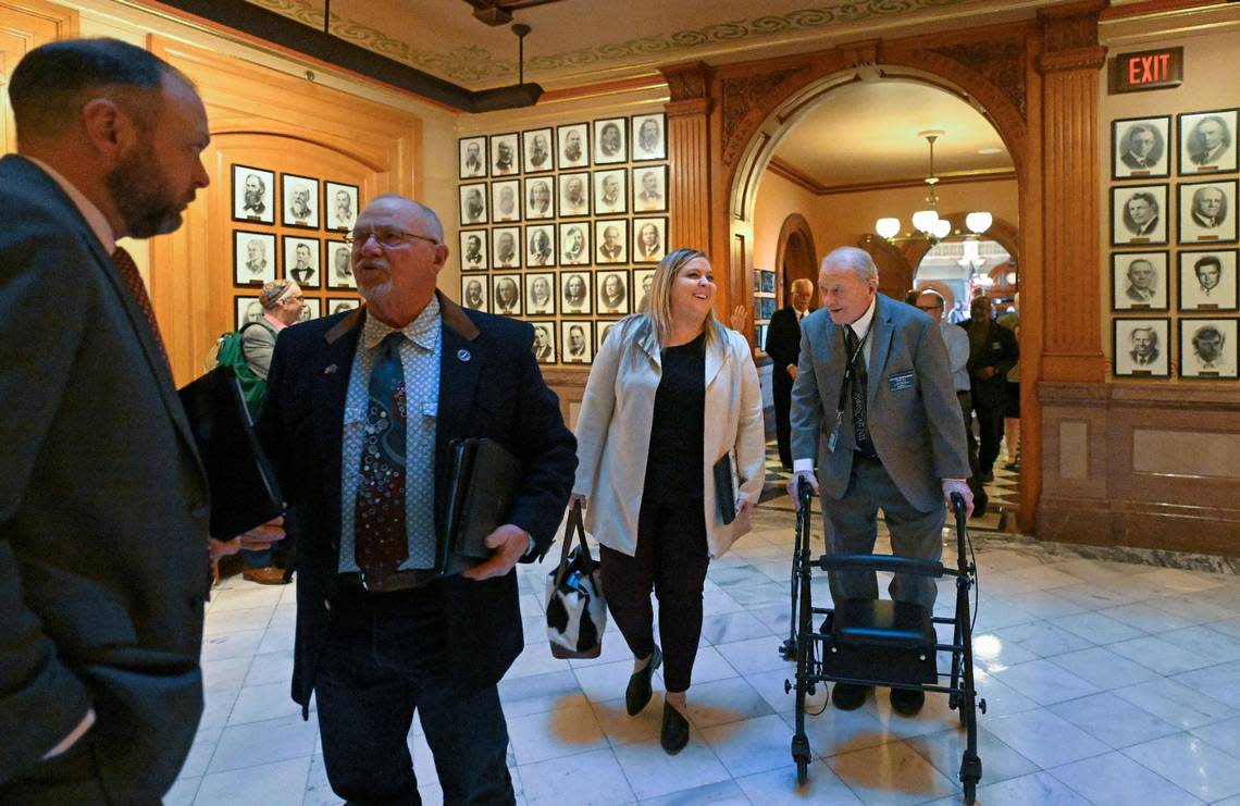 Rep. Tory Blew, center, a Great Bend Republican, walks with Rep. Owen Donohoe, right, a Shawnee Republican, as the Kansas House finishes the session on Tuesday.