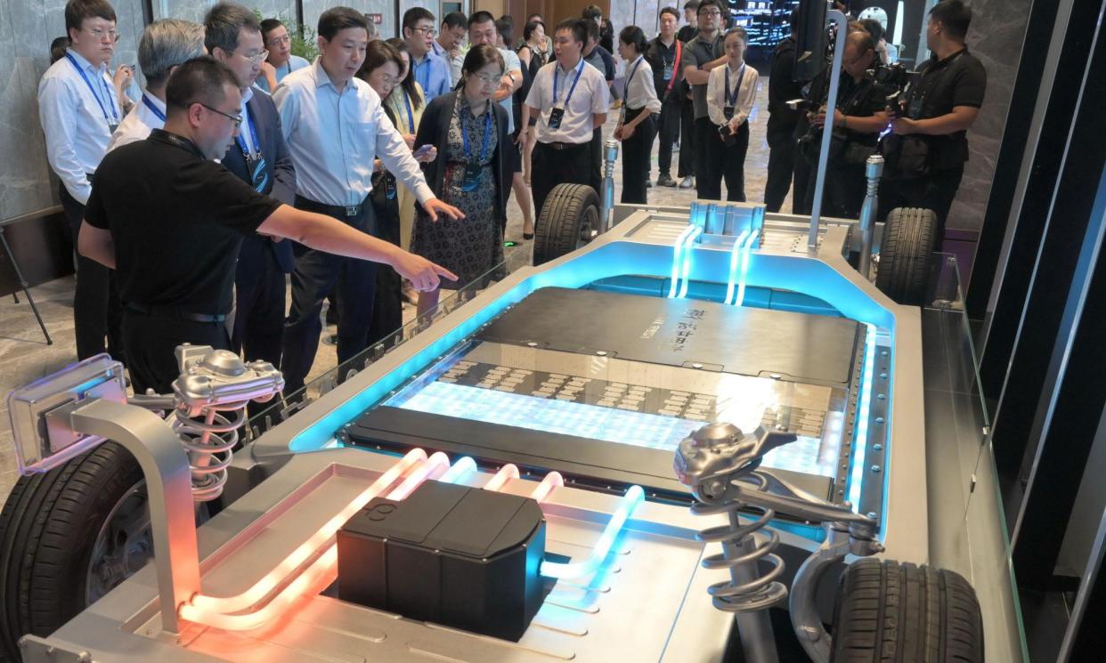 <span>Visitors look at CATL’s Shenxing superfast charging battery at its operation in Ningde, south-east China.</span><span>Photograph: Xinhua/Alamy</span>