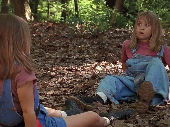 Mary-Kate and Ashley Olsen in "It Takes Two" on the ground in the woods