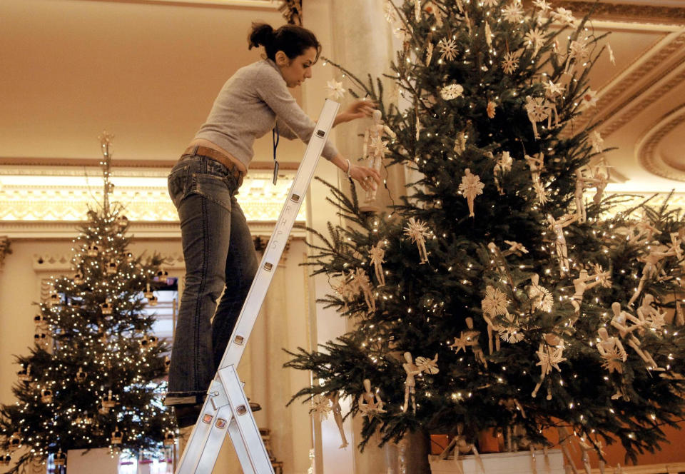 STANDALONE PHOTO  Haleh Niazi of Chelsea College of Art & Design helps decorate a christmas tree in Buckingham Palace today in preparation for tomorrow's young acheivers reception hosted by the Queen and other members of the Royal family.   (Photo by Stefan Rousseau - PA Images/PA Images via Getty Images)