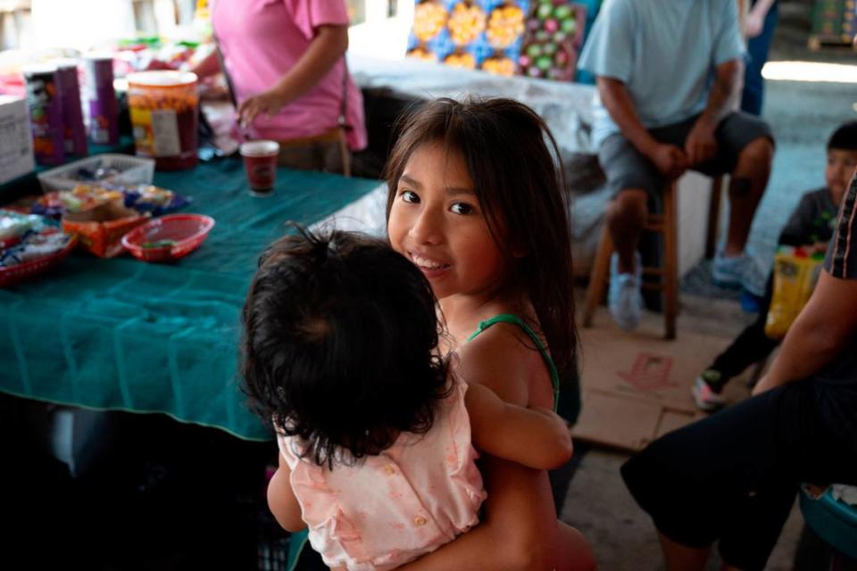 Delores Bautista holds eight month old Marisol at her family’s stand at the Buckhorn Flea Market on Saturday, June 15, 2024.