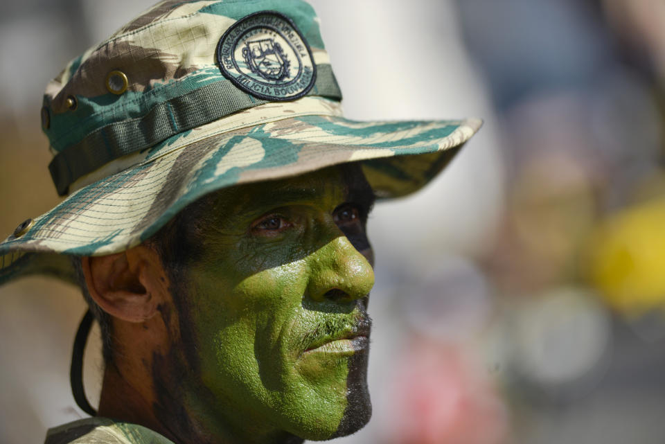 A member of the Bolivarian National Militia takes part in an invasion drill in Caracas, Venezuela, Saturday, Feb. 15, 2020. Venezuela's President Nicolas Maduro ordered two days of nationwide military exercises, including participation of civilian militias. (AP Photo/Matias Delacroix)