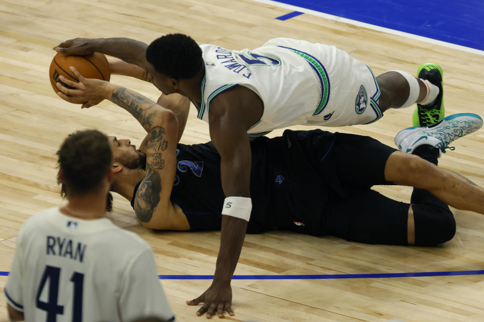 Dallas Mavericks center Dereck Lively II (2) and Minnesota Timberwolves guard Anthony Edwards (5) scramble for the ball during the second half of Game 2 of the NBA basketball Western Conference finals, Friday, May 24, 2024, in Minneapolis. (AP Photo/Bruce Kluckhohn)