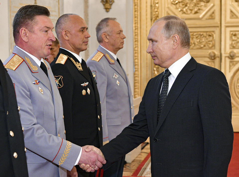 FILE - Russian President Vladimir Putin, right, and Lt. Gen. Alexander Lapin, the chief of Russia's Central Military District, left, attend an awarding ceremony in the Kremlin in Moscow, Russia, on May 31, 2018. (Alexei Druzhinin, Sputnik, Kremlin Pool Photo via AP, File)