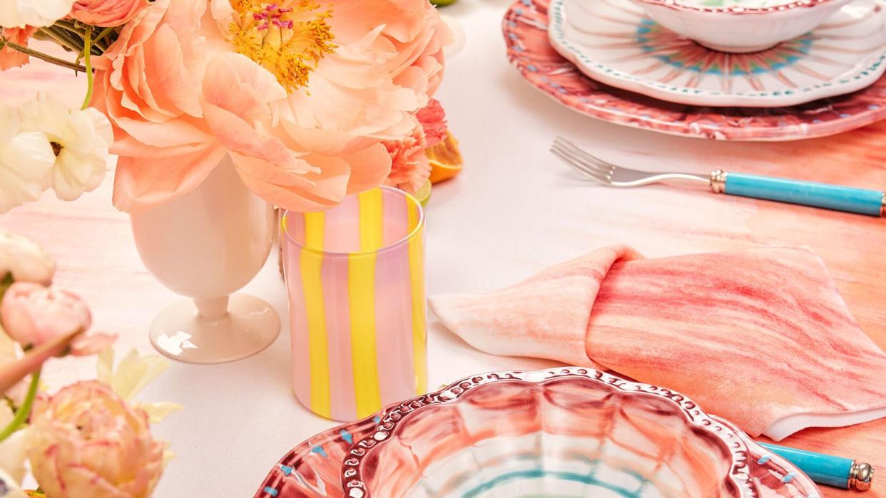 a table with plates and oranges