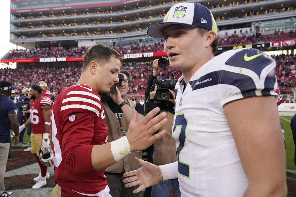 San Francisco 49ers quarterback Brock Purdy, left, greets Seattle Seahawks quarterback Drew Lock after an NFL football game in Santa Clara, Calif., Sunday, Dec. 10, 2023. (AP Photo/Godofredo A. Vásquez)