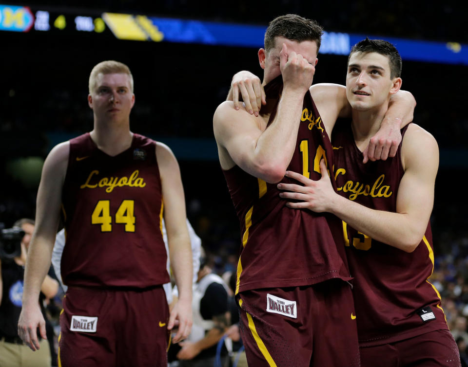 Loyola-Chicago's Ben Richardson embraces with Clayton Custer, right, after the Ramblers lost to Michigan in the Final Four. (AP) 