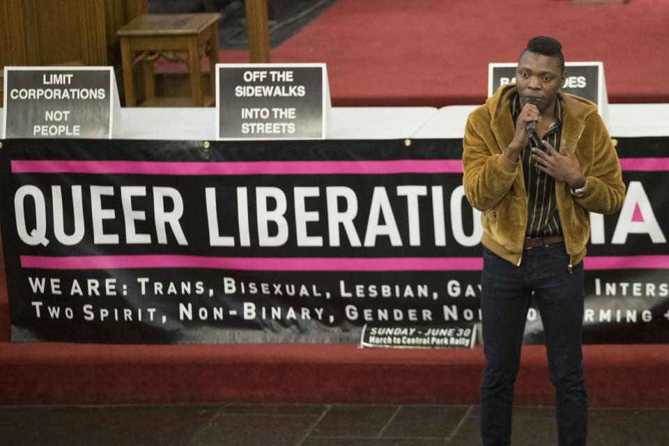 In this March 27, 2019, photo, Nigerian activist Michael Ighodaro speaks during a meeting of the Reclaim Pride Coalition at the Church of the Village in New York. Activists who believe New York City’s annual LGBTQ Pride march has become too commercialized are staging an alternative march the same day. The two marches through Manhattan streets will take place Sunday, June 30, the last day of a month of celebrations marking the 50th anniversary of the 1969 Stonewall uprising. (AP Photo/Mary Altaffer)