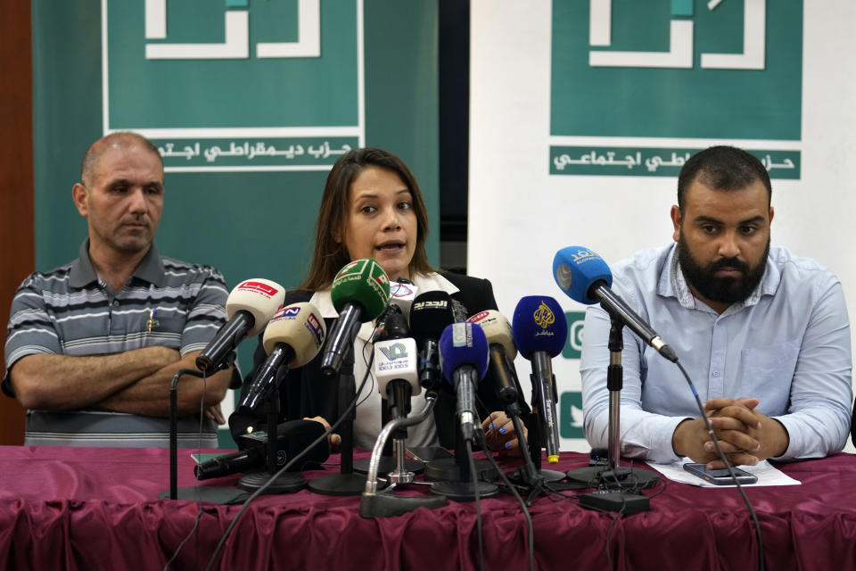 Diala Chehade, center, with other lawyers representing the families of the victims and survivors of a drowned migrant boat announces two lawsuits against the Lebanese Army, accusing them of holding two missing survivors, in Tripoli, northern Lebanon, Thursday, Sept. 1, 2022. In late April, a boat carrying about 80 Lebanese, Syrians, and Palestinians trying to migrate by sea to Italy sunk following a confrontation with the Lebanese navy. (AP Photo/Bilal Hussein)