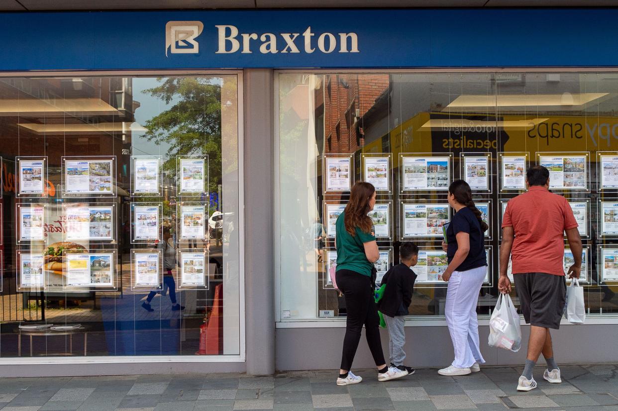 Housing: People look in the window of an Estate Agents in Maidenhead, Berkshire