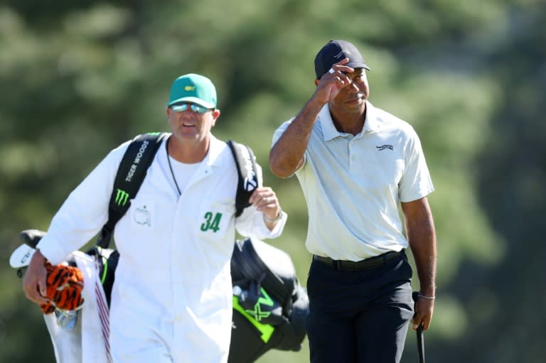 Tiger Woods acknowledges the crowd walking to the 18th green in his worst-ever Masters round, a 10-over par 82, during the third round of the 88th Masters (Andrew Redington)