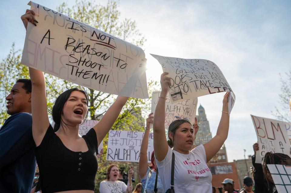 Anna Donigan, left, and Donna Camargo hold up signs with other community members during a rally for Ralph Yarl Tuesday in front of the Charles E. Whittaker U.S. Courthouse.