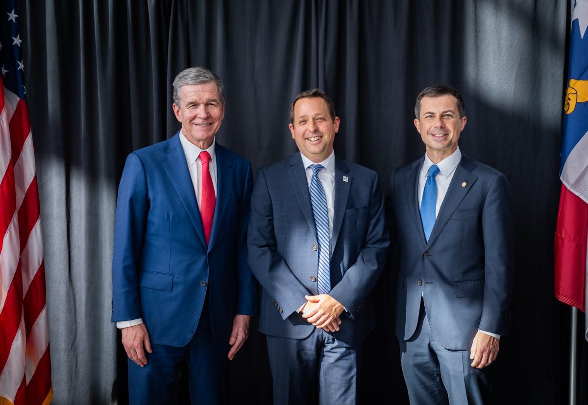 Gov. Roy Cooper (left), N.C. DOT Rail Division Director Jason Orthner (middle), and U.S. Secretary of Transportation Pete Buttigieg (right) pose at the Dec. 11 grant announcement event at Raleigh Union Station.