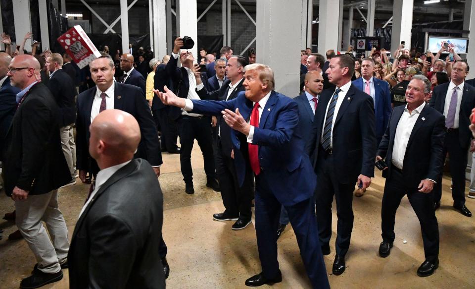 Donald Trump tosses boxes of popcorn to fans at Bryant-Denny Stadium before a football game between the Alabama Crimson Tide and the Georgia Bulldogs (USA TODAY Sports via Reuters Connect)