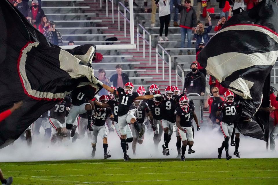 Nov 21, 2020; Athens, Georgia, USA; The Georgia Bulldogs run through their banner on to the field prior to the game against the Mississippi State Bulldogs at Sanford Stadium. Dale Zanine-USA TODAY Sports