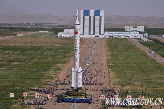 The Shenzhou 10 spaceship atop its Long March 2F rocket booster has been rolled out to launch pad.