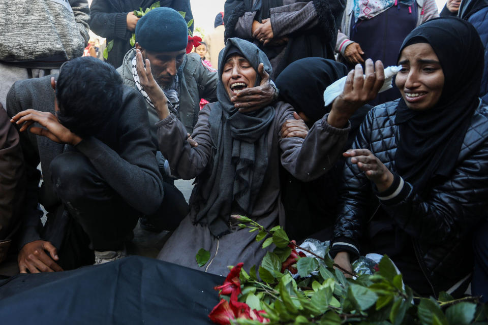 KHAN YUNIS, GAZA - DECEMBER 24: People mourn as they collect the bodies of Palestinians killed in an airstrike on December 24, 2023 in Khan Yunis, Gaza. The United Kingdom, France and Germany are the latest countries to call on Israel to reach a 