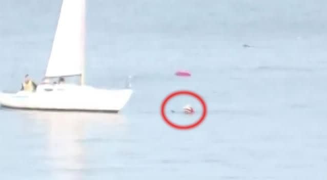 The man is rescued by a father, wife and daughter on a boat. Photo: Gene Mace Jr via Storyful